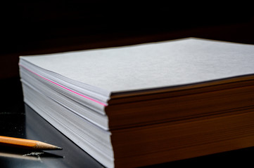 Single colored sheet in a stack of plain white paper