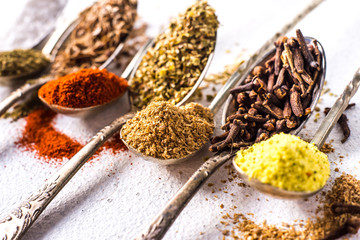  Various spices ground turmeric pepper ginger cinnamon herb seasoning salt paprika caraway seeds on the table. View from above. fragrant indian spices