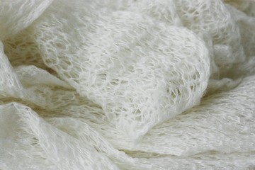 Beautiful white knitted scarf close up view 
