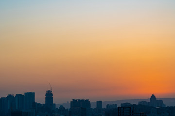 Fototapeta premium Modern city skyline in sunset time with colourful sky background
