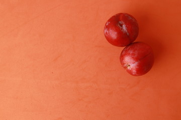 Delicious plums in colorful background