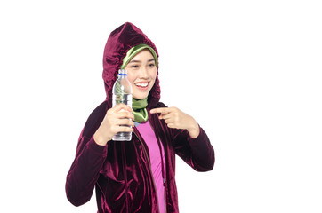 Portrait of a active healthy hijab woman drinking plain water in bottle for promoting a healthy fitness and lifestyle concept