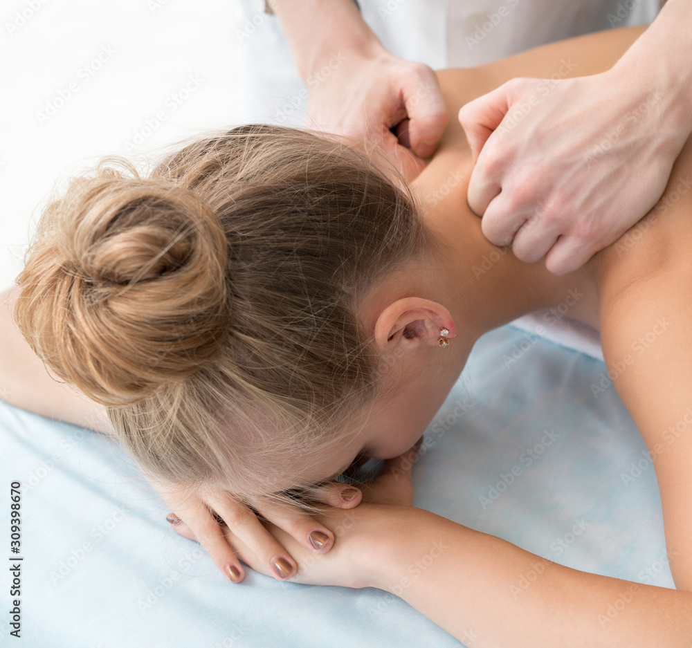 Wall mural Girl being massaged in spa salon