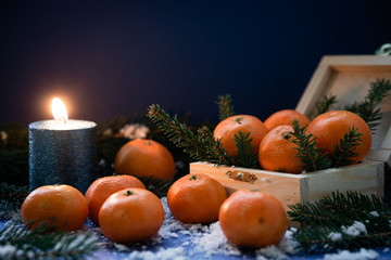 Fototapeta na wymiar Banner with place for text on blue background. Tangerines in Christmas card