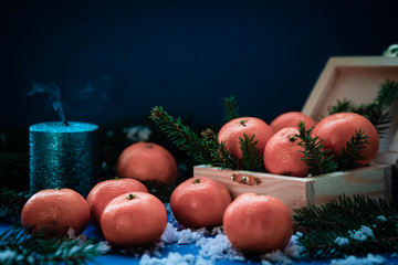 Fototapeta na wymiar Tangerines in a box for Christmas gift.