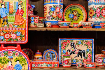 Close up wooden hand-painted Russian souvenirs on shelves