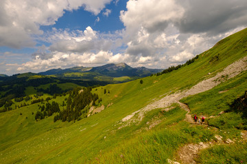 Hikers family trekking in Switzerland Alps
