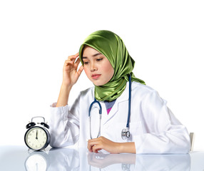 Young depressed hijab woman healthcare practitioner holding face in despair expressing her stress and tired with work concept.