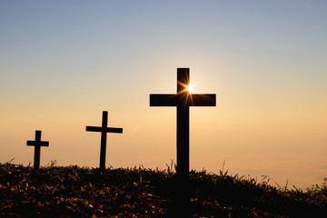 Silhouette cross on mountain at sunset background.Crucifixion Of Jesus Christ
