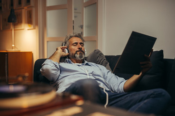 middle aged man listening records at home
