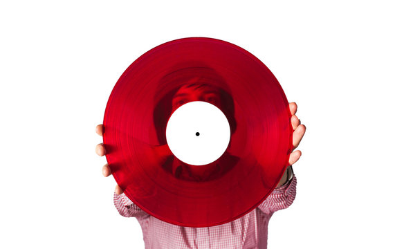 A man hides behind a red vinyl record. Isolate on a white background.