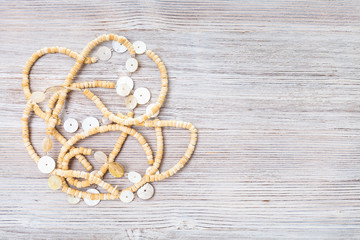 top view of bone necklace on gray wooden board