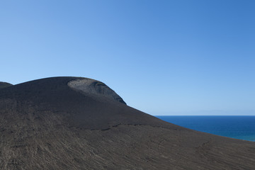 Fototapeta na wymiar Volcanic rock and ocean