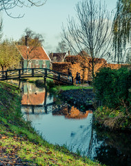 the country side of netherlands, the famous village attraction Zanse schans with the vintage houses the fields and the mills