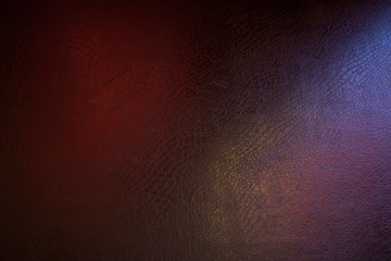 black leather background with pink and green highlight