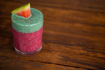 Glass of black chia pudding with watermelon taste