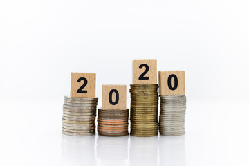 Wooden blocks 2020, placed on stack coins, Image use for business concept, new year