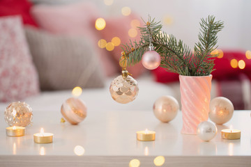 Christmas decorations with burning candles in pink and gold colors