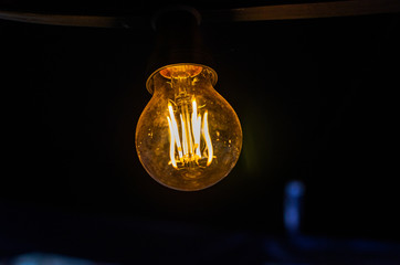 Incandescent light bulb illuminates the dark