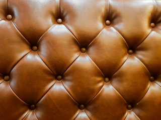surface of luxury brown leather sofa couch. Close up shot for the detail of material, for vintage elegant lifestyle interior home decoration. 
