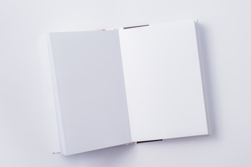 Flat lay mockup with white open notebook on a white background