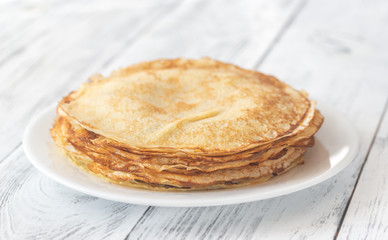 Stack of crepes on the white plate