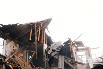 Destroyed old wooden house. Demolition of the house.