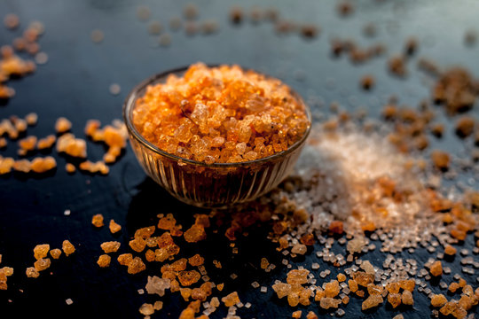 Close up shot of gond/goond/edible gum crystals in a transparent glass bowl on a black glossy surface with some spread. Edible gum or Tragancath in a glass bowl.Horizontal shot.