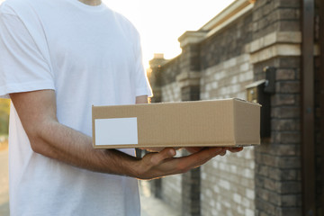 Delivery man hold blank box outdoor, space for text