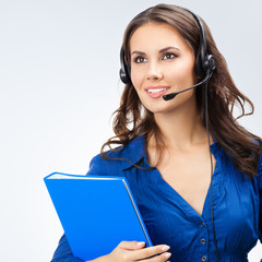 Portrait of happy smiling beautiful young support phone operator or sales phone agent in headset...