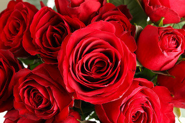 Bouquet of beautiful red roses, close up. Textured background