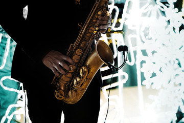 saxophonist play music with saxophone outdoor