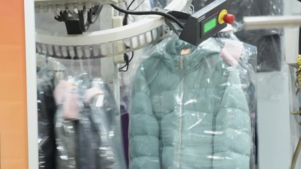 Clothes on the conveyor goes to the dry cleaner