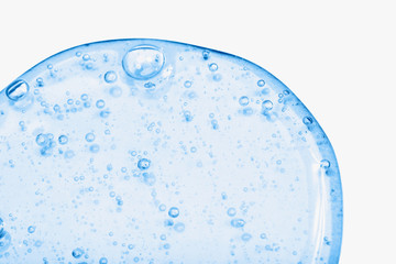 Close-up of serum or cosmetic gel in trendy blue color. The drop isolated on the white background. Collagen, hyaluronic acid for skin care.