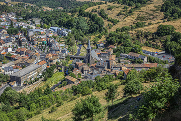Picturesque view of Saint-Flour (Sant Flor) lower town. Ander and Margeride mountains in the background. Saint-Flour, Cantal department, Auvergne region, France.
