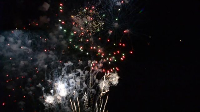 Colorful fireworks that explode and fill the darkness of the night sky with colored light.