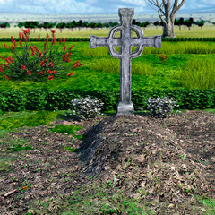 View of a large, well-groomed grave in a cemetery with plants during the day and great cloud cover. Large metal christian cross. Forest on the horizon