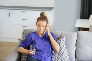 Portrait of young woman suffering from ache.