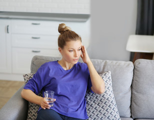 Portrait of young woman suffering from ache.