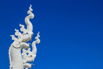 Fototapeta na wymiar White serpent on blue sky background.