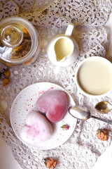 Two homemade heart shaped cakes, a cup of coffee, cream and dried rosebuds on a rustic napkin. Flatlay for romantic mood  