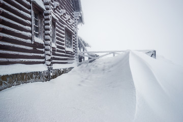 Large wooden house covered with snow
