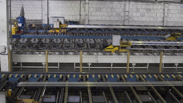 Modern Aluminium extrusion production line in factory. Production of Complex lightweight extruded aluminium metal profiles, commonly used as material in construction and manufacturing