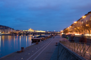  Night city landscape and panorama in the bright evening lights of the Czech capital Prague overlooking the Vltava River.