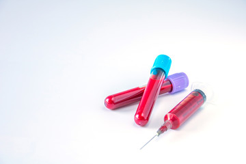 Test tubes and needle for blood in laboratory isolated on a white background.
