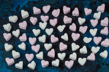 heart shaped marshmallows on blue background
