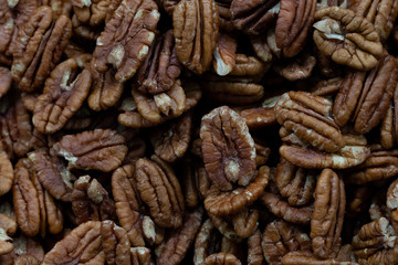 Peeled dry brown walnuts seeds in bulk. Top View.