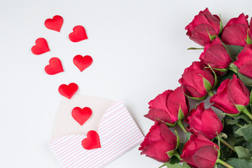 on a white background a bouquet of red roses and red hearts fly out of an envelope