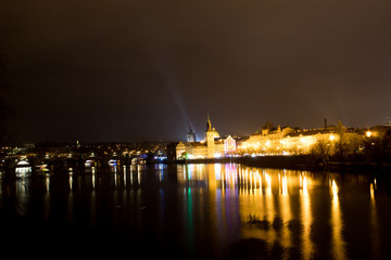  Night city landscape and panorama in the bright evening lights of the Czech capital Prague overlooking the Vltava River.