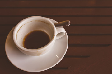 Empty coffee cup after drink on wood table.